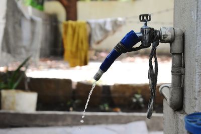 Close-up of faucet against wall