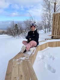 Low section of snowboarding girl against sky