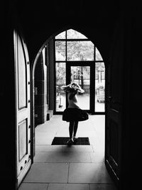 Rear view of girl walking in corridor