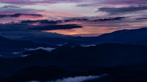 Silhouette landscape against scenic sky