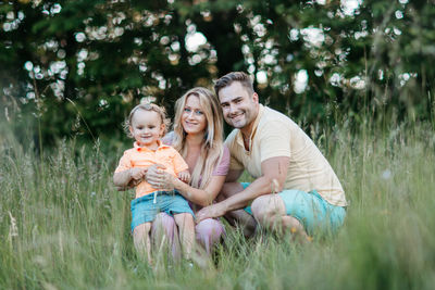 Portrait of smiling family on field at park