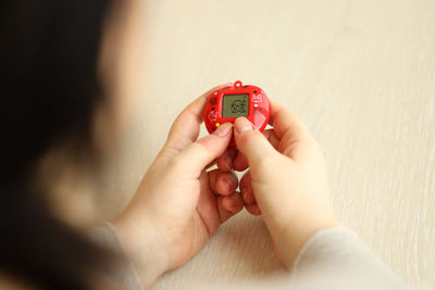 Cropped hand of person holding wristwatch