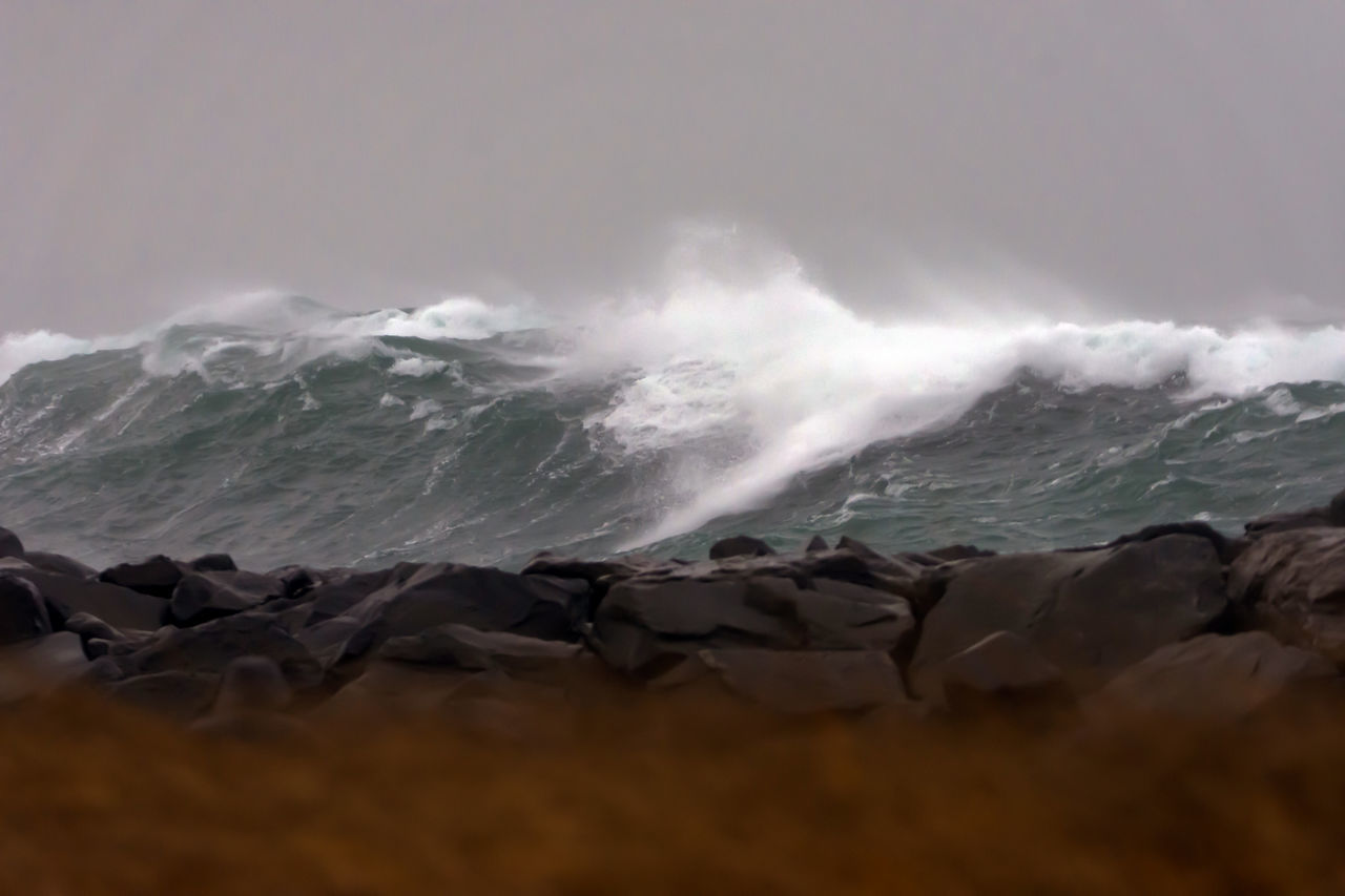 WAVES SPLASHING ON ROCKS AT BEACH