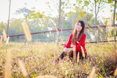 Portrait of young woman on field