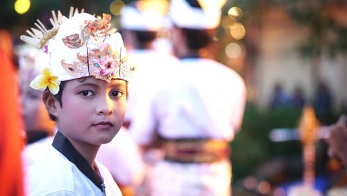 Close-up portrait of boy wearing headdress