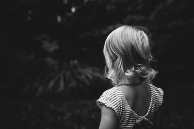 Rear view of girl standing outdoors