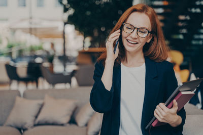 Portrait of young woman using mobile phone