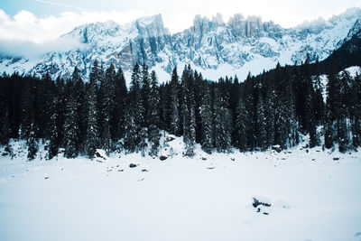 Panoramic view of snow covered mountains against sky during winter
