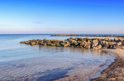 Scenic view of sea against blue sky