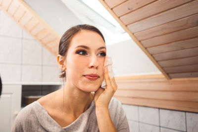 Portrait of young woman sitting at home