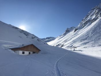 Scenic view of snowcapped mountains against clear blue sky