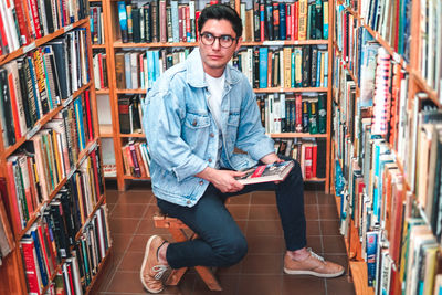 Portrait of young man reading book