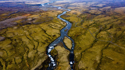 Aerial view of stream amidst land