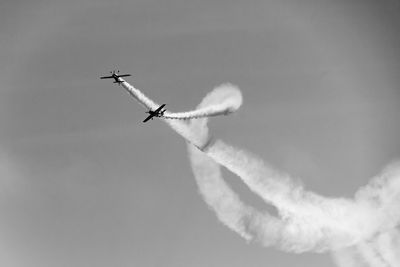 Low angle view of airplane in flight against sky