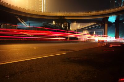 Light trails on road in city at night