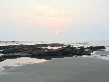 Scenic view of beach against sky during sunset