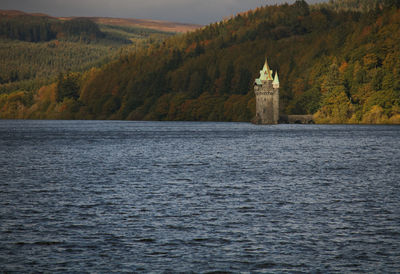 Scenic view of lake by building during autumn