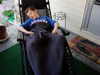 High angle view of boy sitting at home