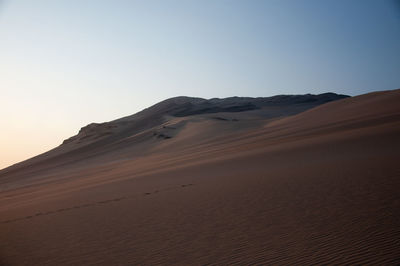 Scenic view of desert against clear sky