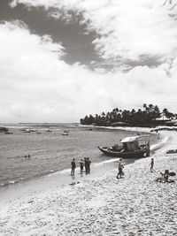 People on beach against sky