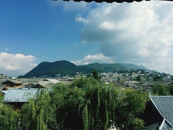 Panoramic view of trees and mountains against sky