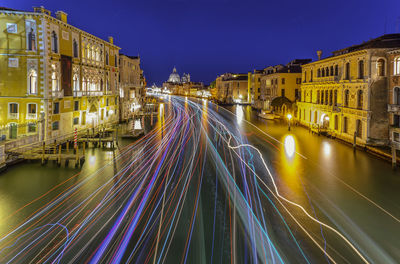 Light trails on illuminated city against clear sky at night, ponte dell'accademia by night