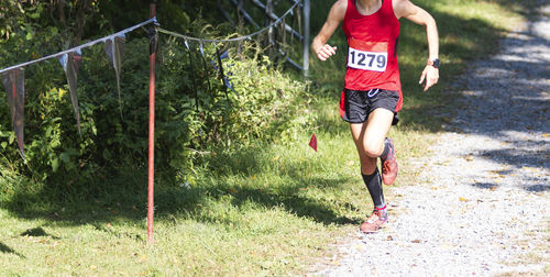 Low section of woman running on plants