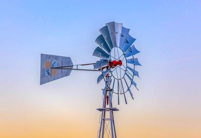 Windmill against clear sky during sunset