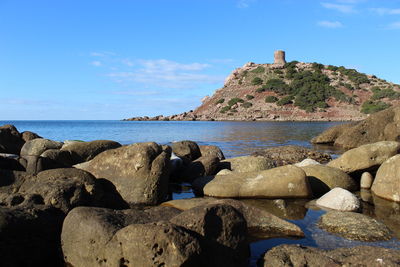Rocks on beach against sky