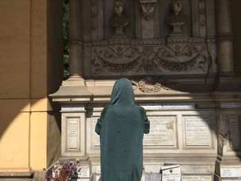 Rear view of woman statue at temple