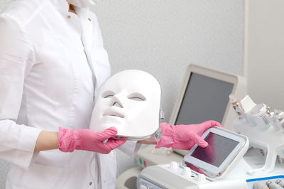 Midsection of woman wearing mask