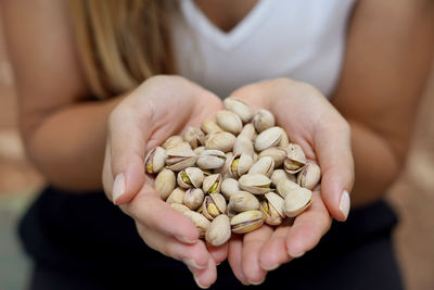 Midsection of woman holding pills