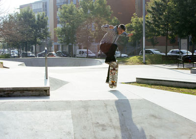 Man skateboarding on ramp in park