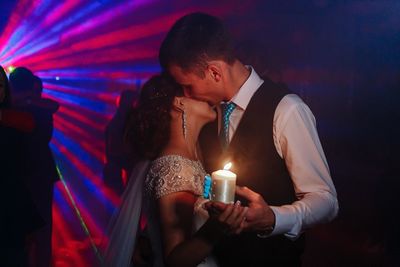 Man holding illuminated lighting equipment