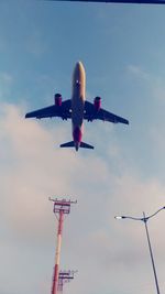 Low angle view of airplane flying against sky