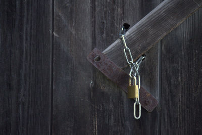 Close-up of padlock on wooden door