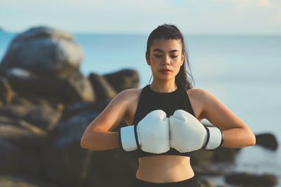 Portrait of young woman exercising in gym