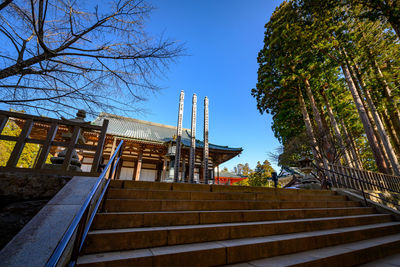 Low angle view of staircase by building against sky