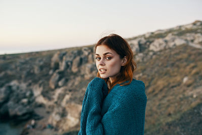 Portrait of young woman standing outdoors