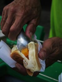 Cropped hand holding food