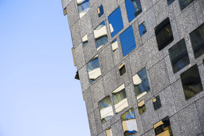 Low angle view of buildings against clear blue sky