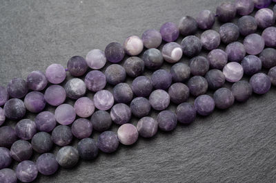 High angle view of purple beads on slate