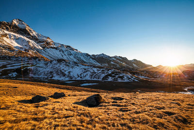 Scenic view of snowcapped mountains against clear sky