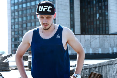 Portrait of young man standing in city