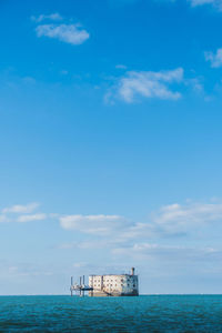 Scenic view of sea against blue sky