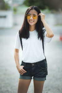 Asian teenager toothy smiling face standing outdoor