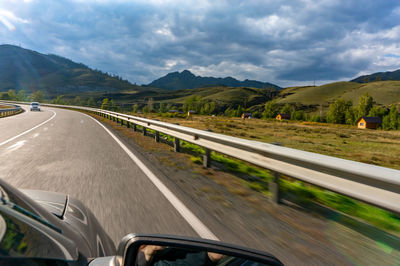 A road in the mountains of the altai republic, taken from a car at high speed.