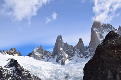 Panoramic view of snowcapped mountains against sky