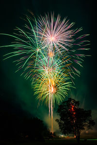 Low angle view of firework display at night