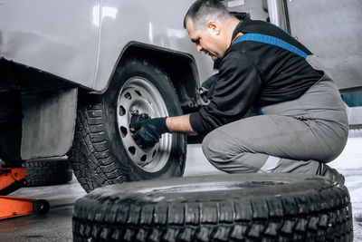 Low section of man cleaning car